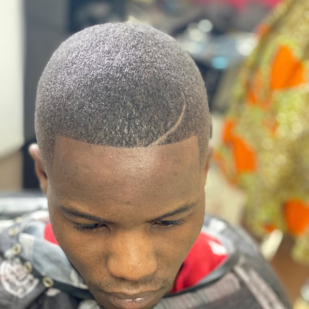 Buzz cut with a sharp lineup and part design