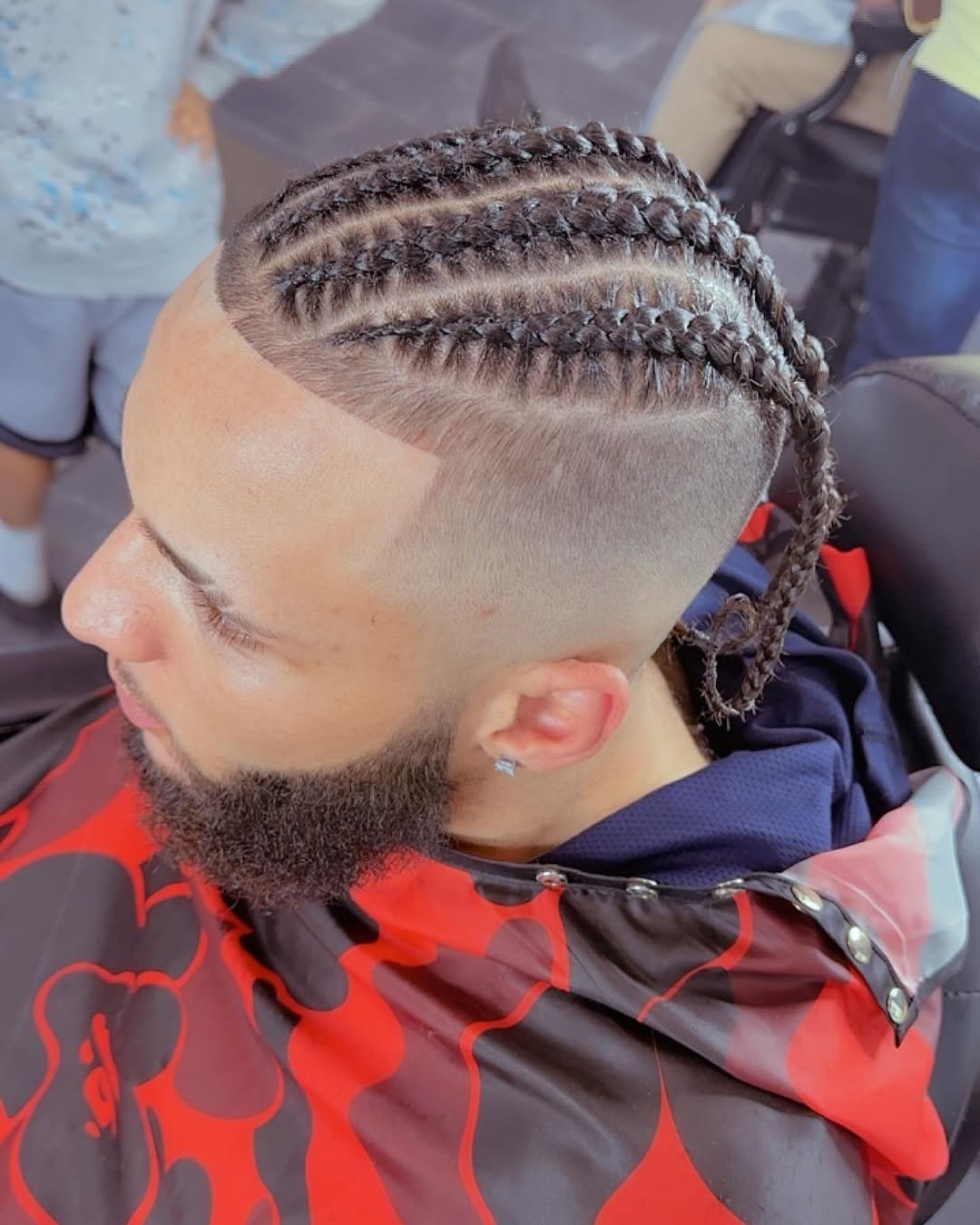 Cornrows with a high fade and beard