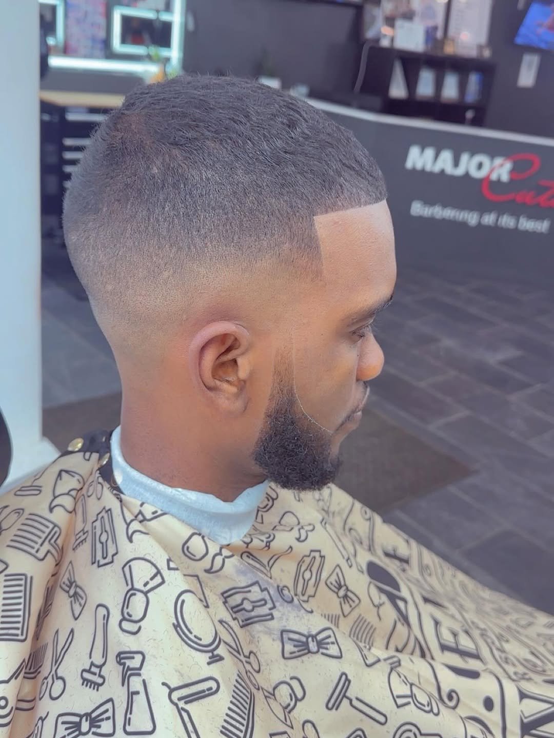 High skin fade with a sharp lineup and full beard, cut at Major Cuts in Lewiston, Maine
